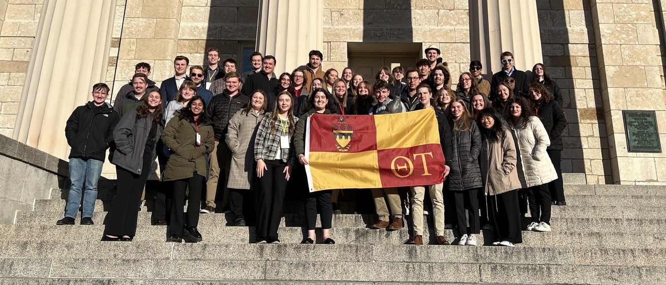 An image of theta tau members standing on the capital steps